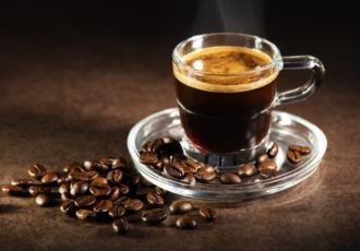 A single serving of espresso in glass cup